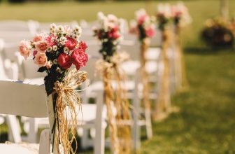 Bows of rope twine pink bouquets to white chairs